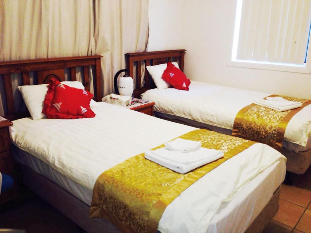 Postel nebo postele na pokoji v ubytování Pure Land Guest House