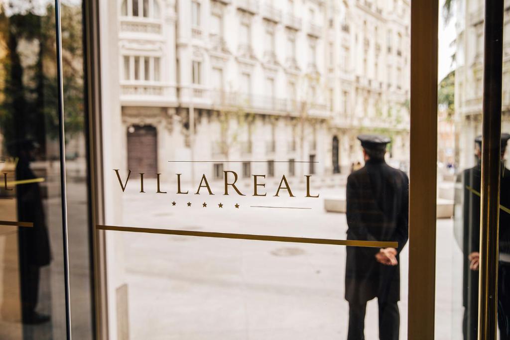 a man standing in front of a window of a building at Hotel Villa Real in Madrid