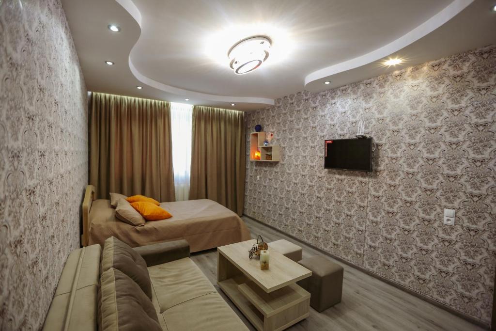 ein Hotelzimmer mit einem Bett und einem Sofa in der Unterkunft N&N House in Tbilisi City
