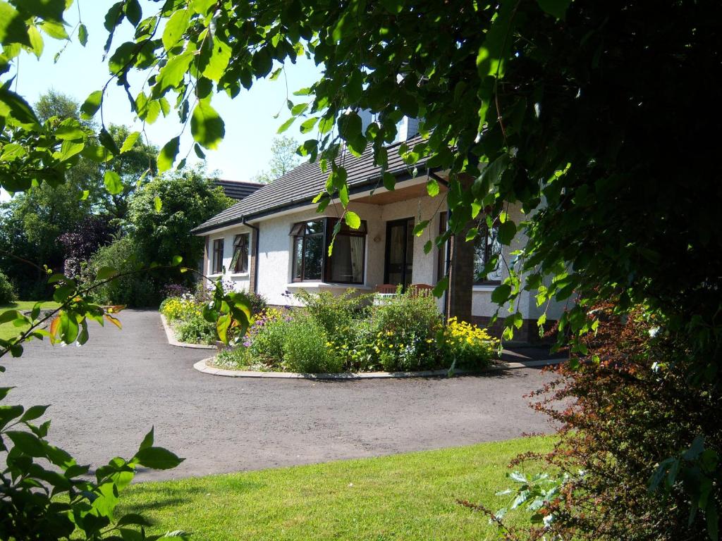 a house with a lot of flowers in front of it at Dewhamill in Bellaghy