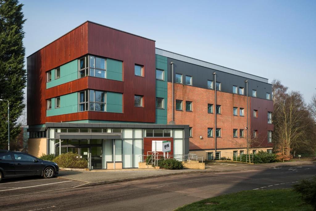 a building with a car parked in front of it at Bonington Student Village (Campus Accommodation) in Sutton Bonington
