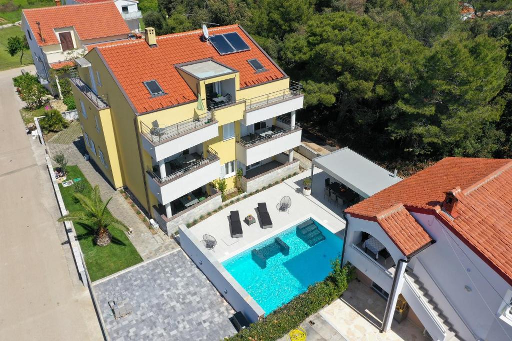 an aerial view of a house with a swimming pool at Luxury Villa Nada with Pool in Petrcane