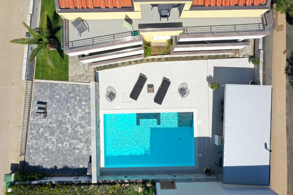 an overhead view of a swimming pool next to a building at Luxury Villa Nada with Pool in Petrcane