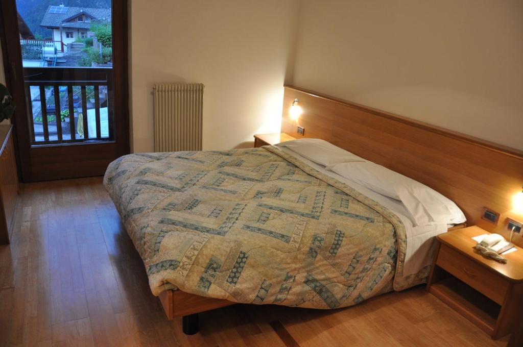 Postel nebo postele na pokoji v ubytování Albergo Dolomiti