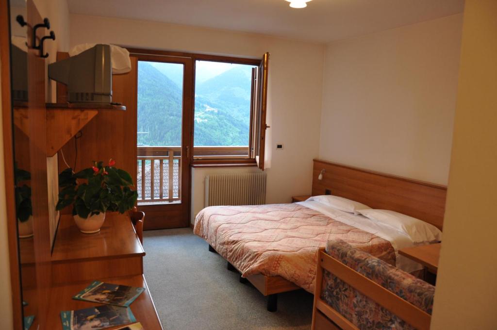 Postel nebo postele na pokoji v ubytování Albergo Dolomiti