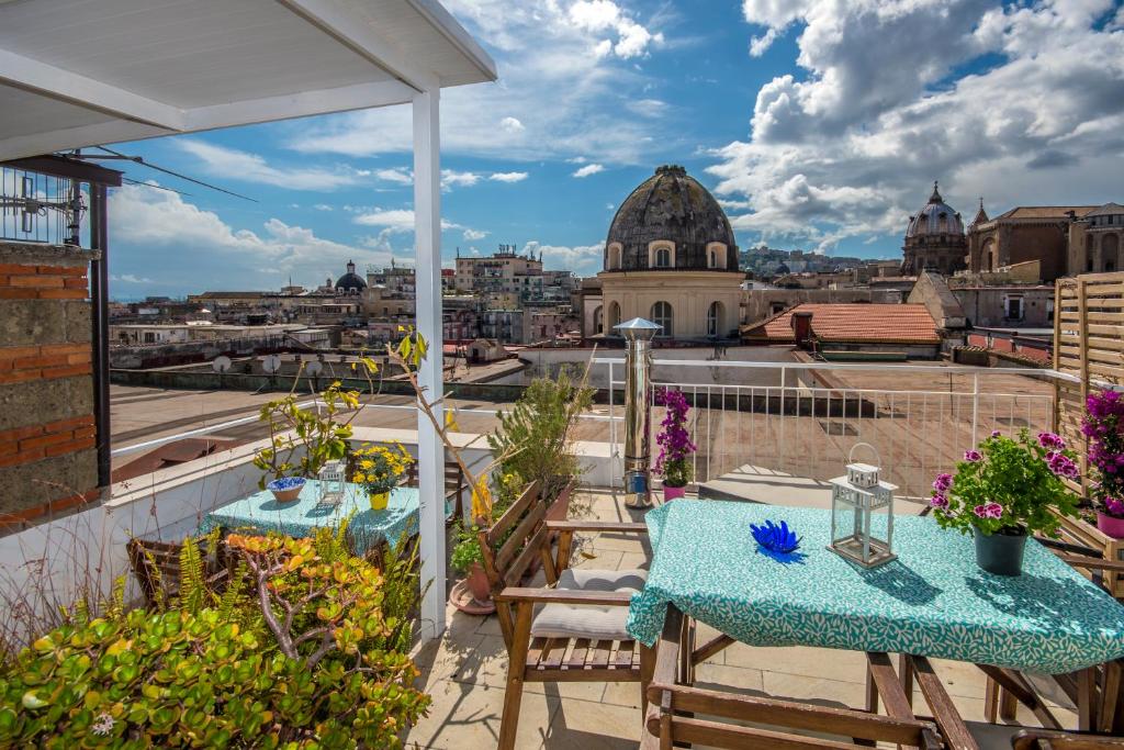 a balcony with two tables and a view of a city at Relais Old Naples from a terrace in Naples