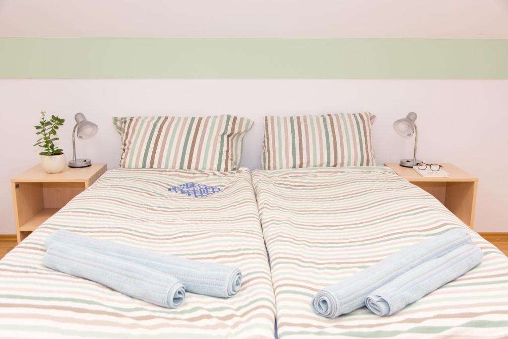 a bed with two pillows on top of it at Apartma Murania in Lendava