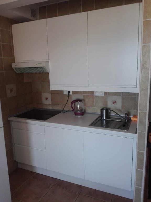 Kuchyň nebo kuchyňský kout v ubytování Orlando Apartments