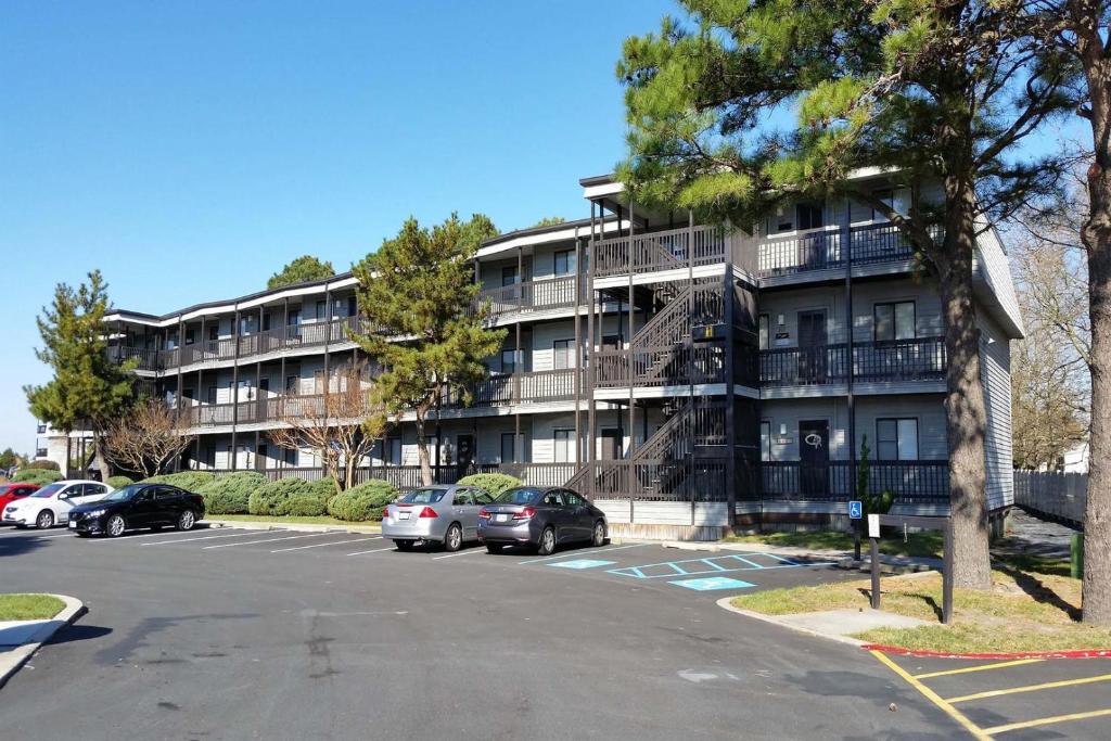 an apartment building with cars parked in a parking lot at Our Place At The Beach 105E Condo in Ocean City