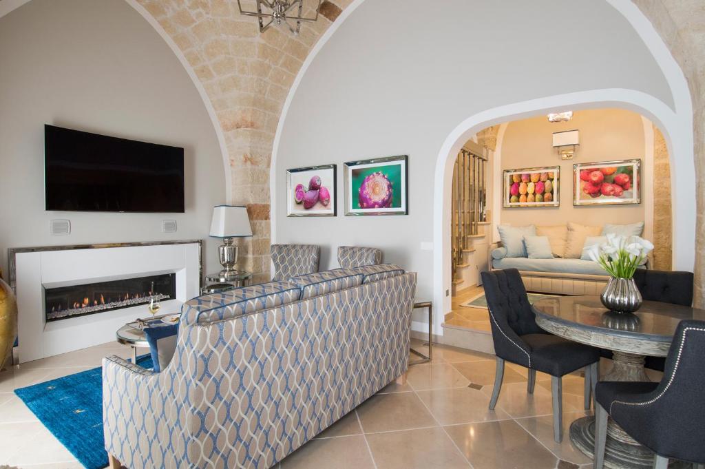 a living room with a couch and a fireplace at Hotel Don Ferrante in Monopoli