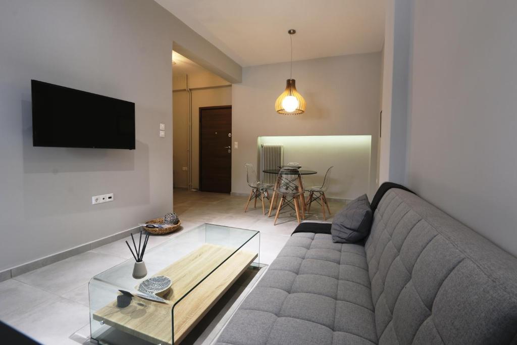 een woonkamer met een bank en een tafel bij The KERAMEIKOS Midtown Apartments in Athene