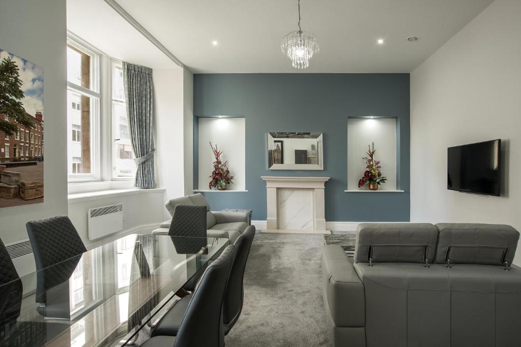 a living room with a glass table and chairs at The Castle Collection - 42 Castle Street in Liverpool