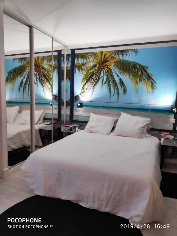 a bedroom with a bed with a view of the ocean at Ô 3 parasols in Sète