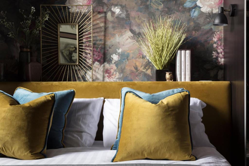 eine gelbe Couch mit Kissen in einem Wohnzimmer in der Unterkunft Luxury Boutique Apt in fashionable Stockbridge 5* in Edinburgh