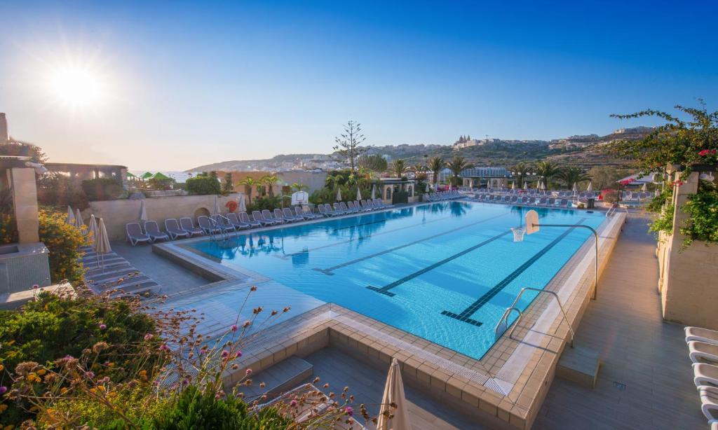 a large swimming pool in a resort at Mellieha Holiday Centre in Mellieħa