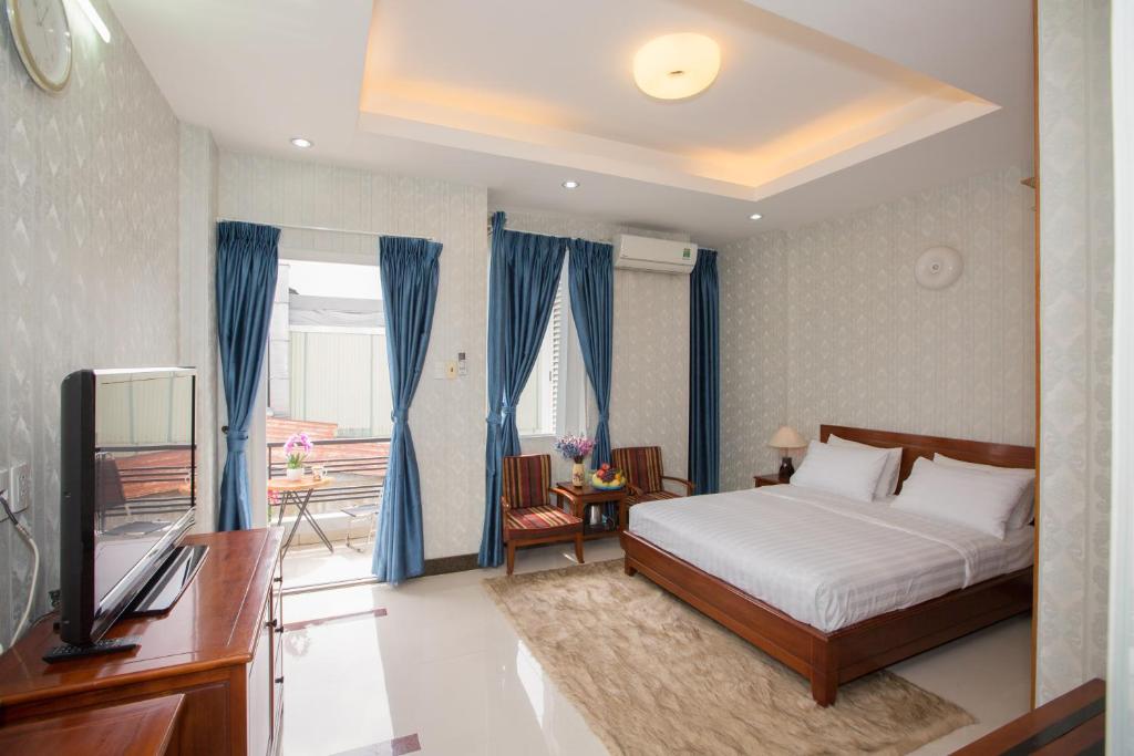 a bedroom with a bed and a television in it at Ben Thanh Retreats Hotel in Ho Chi Minh City