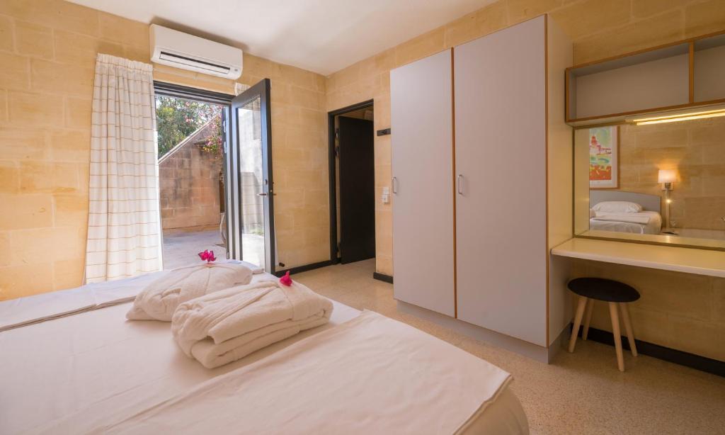 a bedroom with a bed with towels on it at Mellieha Holiday Centre in Mellieħa