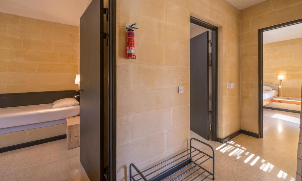 a room with a bed and a chair in a room at Mellieha Holiday Centre in Mellieħa