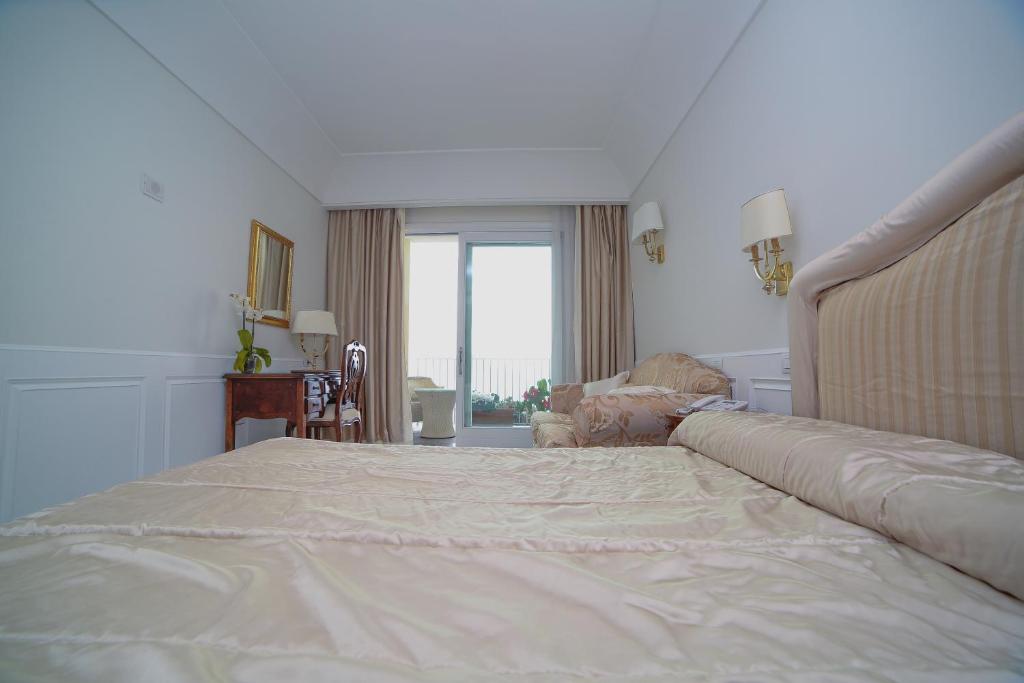 Postel nebo postele na pokoji v ubytování Hotel Villa Fraulo