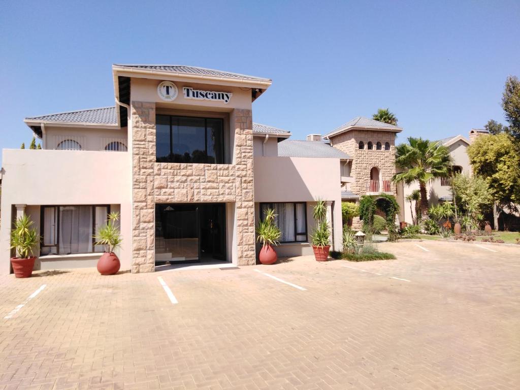 a building with a parking lot in front of it at Tuscany Vryburg in Vryburg