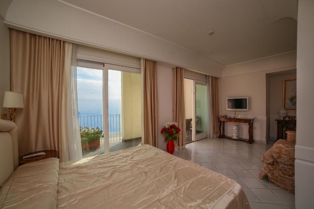 Postel nebo postele na pokoji v ubytování Hotel Villa Fraulo