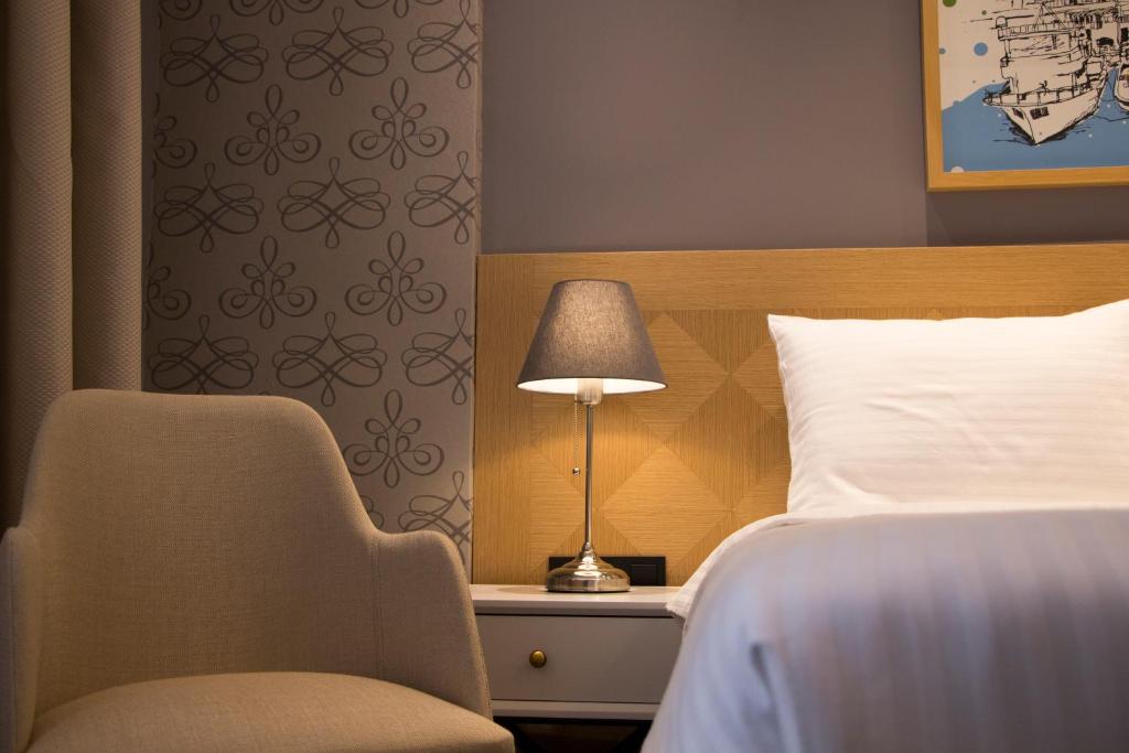 Postel nebo postele na pokoji v ubytování Four-G Hotel
