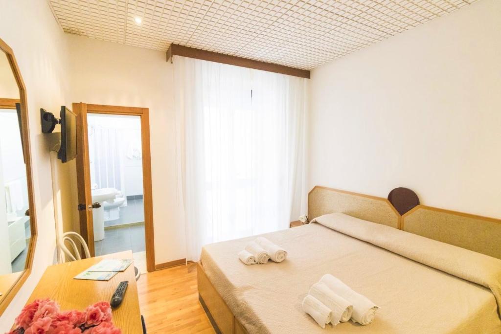 Postel nebo postele na pokoji v ubytování Albergo Palazzo