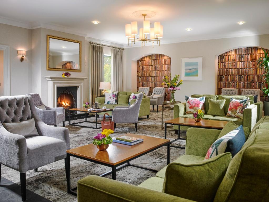a living room with couches and chairs and a fireplace at Clonakilty Park Hotel in Clonakilty