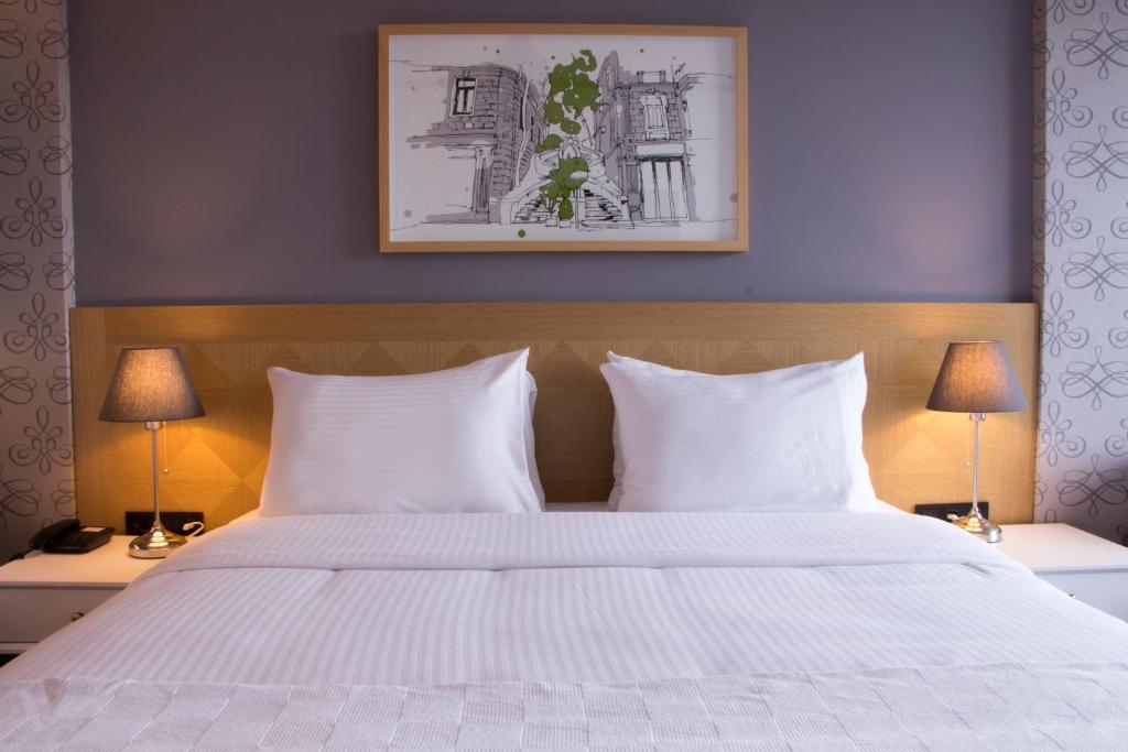Postel nebo postele na pokoji v ubytování Four-G Hotel