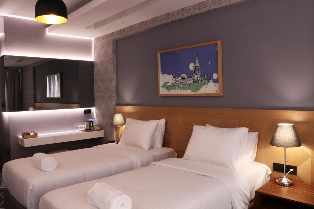 Postel nebo postele na pokoji v ubytování Four-G Hotel