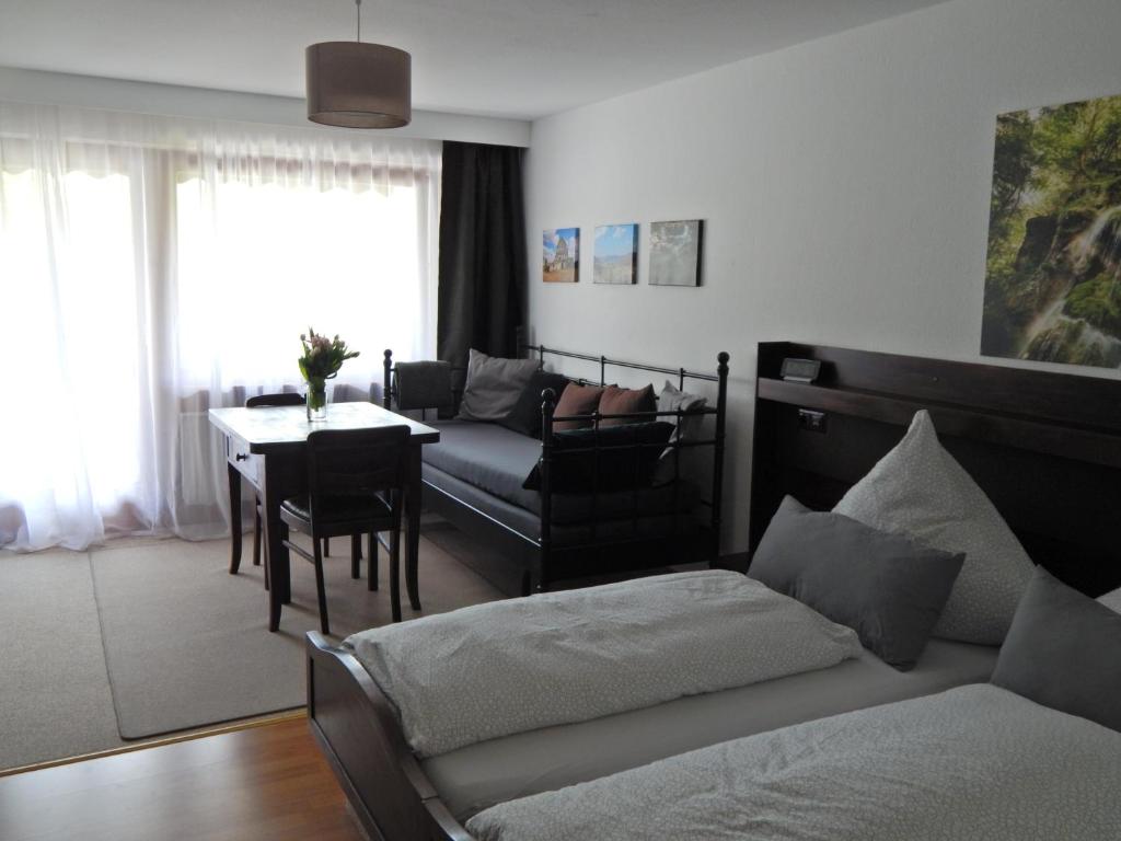 a living room with a couch and a table at FREE Apartment - Burgblick in Bad Urach