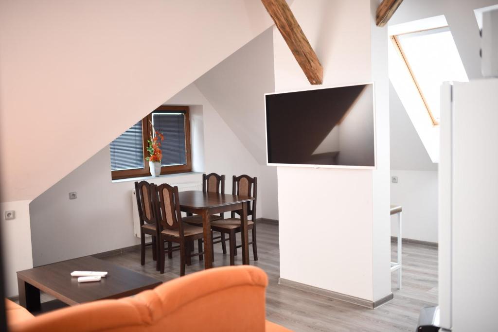 a dining room and kitchen with a table and chairs at Villa u Arény in Ostrava