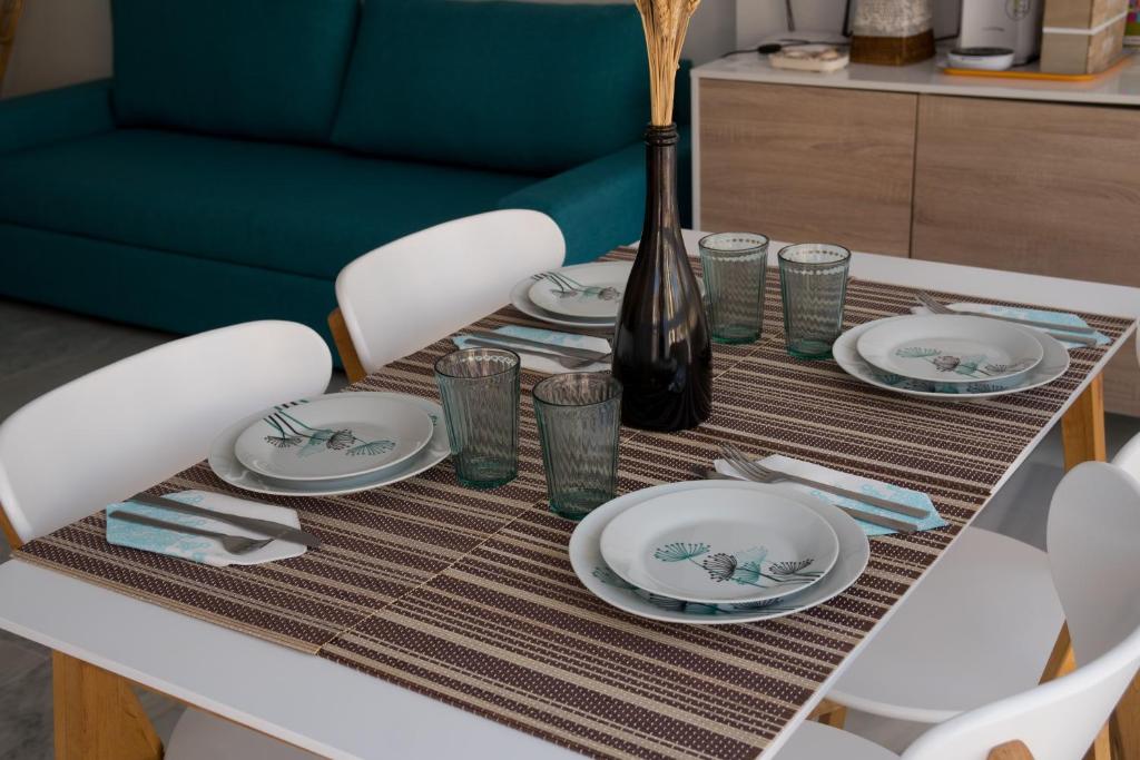 a dining room table with plates and a vase on it at Apartamento Punta de Torrox in Torrox