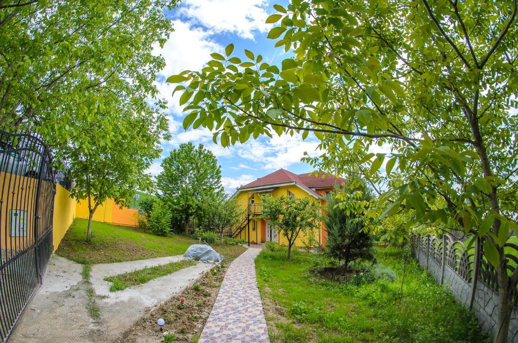 a walkway in front of a house with a fence at Casa Liana in Oradea