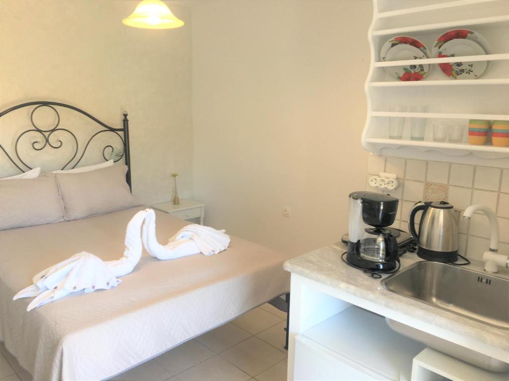 a small kitchen with a sink and a counter top at Pension Sofia Amorgos-Katapola in Katapola