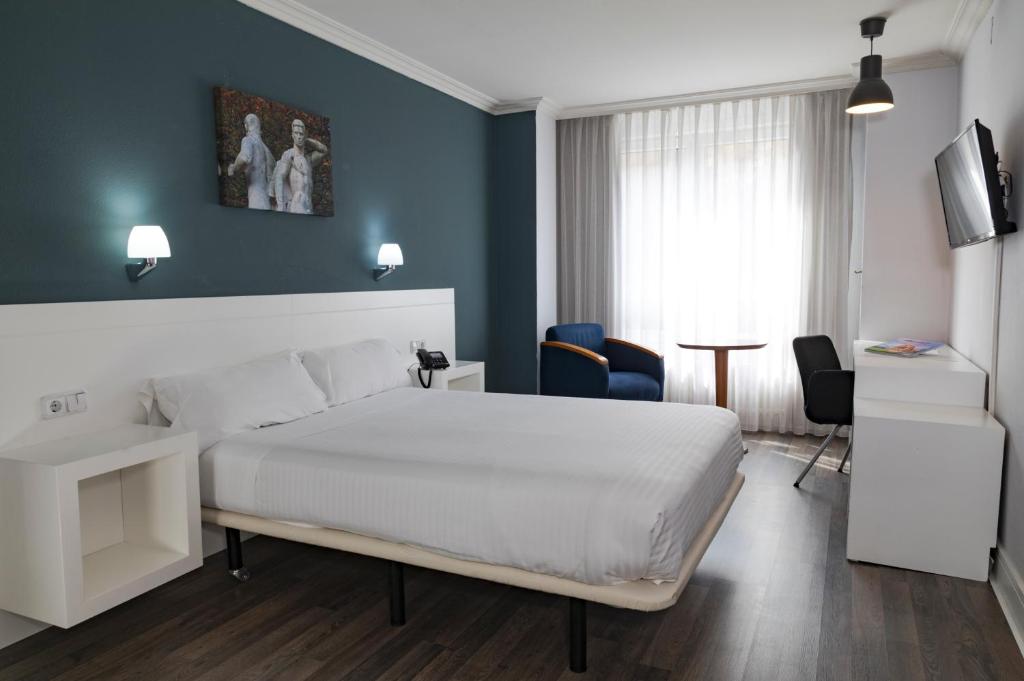 Postel nebo postele na pokoji v ubytování Hotel Gran Regente
