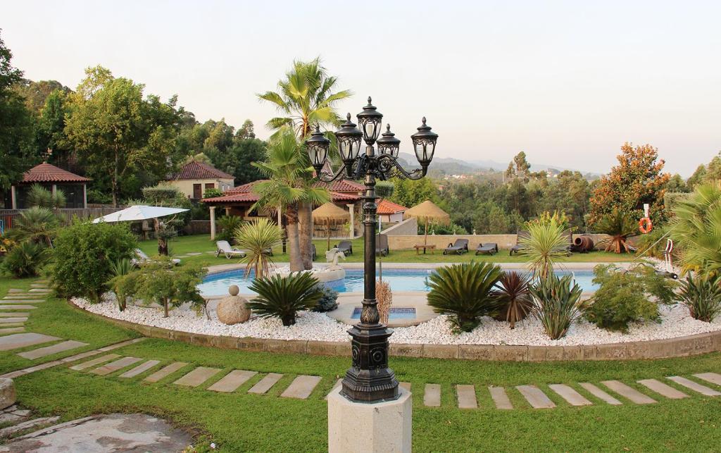 a street light in front of a swimming pool at Casas do Picoutinho in Ponte de Lima