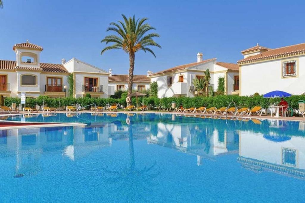 a large swimming pool in front of a house at APARTAMENTO VERA playa in Vera