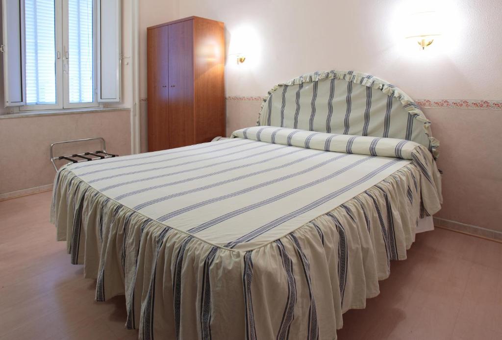 Postel nebo postele na pokoji v ubytování Hotel Lazzari