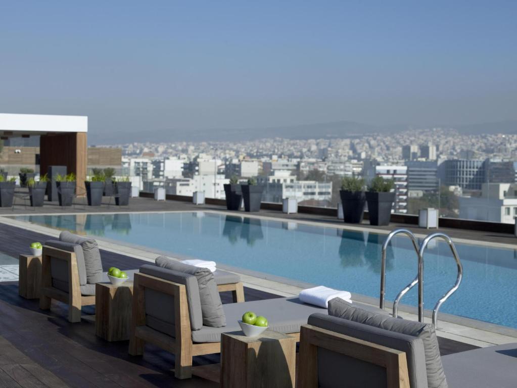 a swimming pool on the roof of a building at The Met Hotel Thessaloniki, a Member of Design Hotels in Thessaloniki