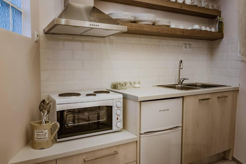 a small kitchen with a stove and a sink at Country Chic in Ioannina city center in Ioannina