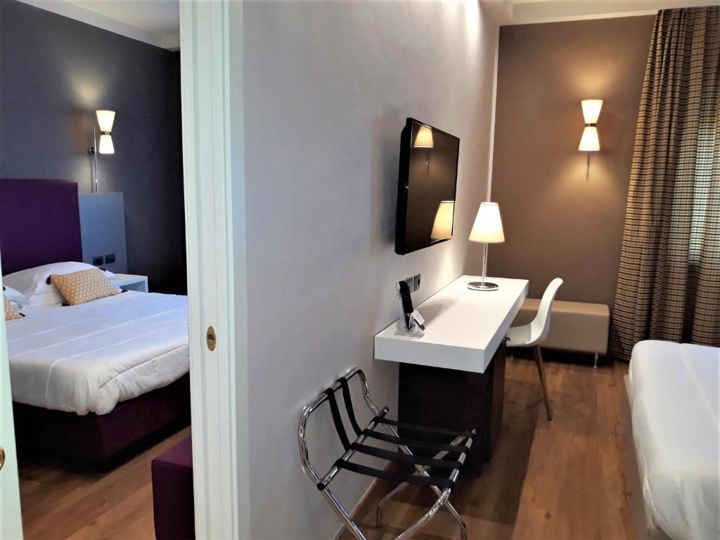 Postel nebo postele na pokoji v ubytování Hotel Umbria