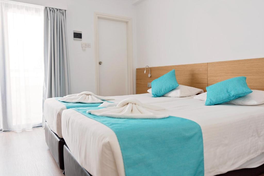 Postel nebo postele na pokoji v ubytování Pyramos Hotel