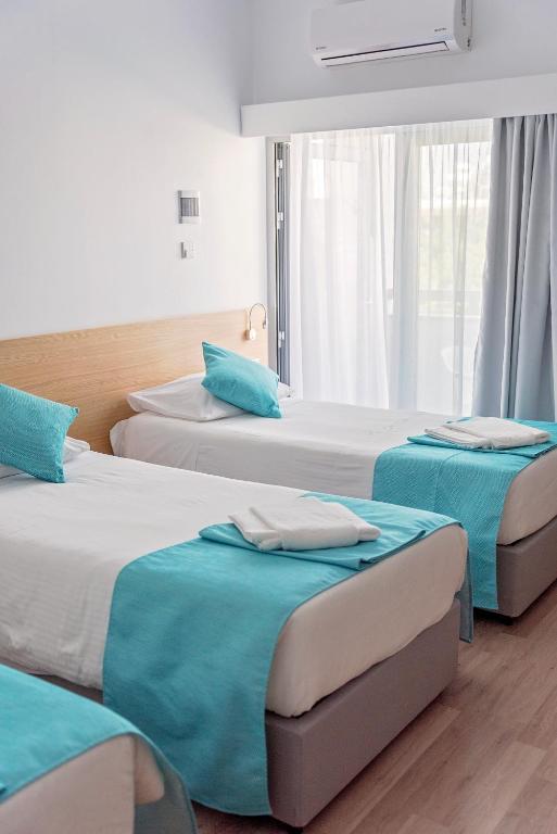 Postel nebo postele na pokoji v ubytování Pyramos Hotel