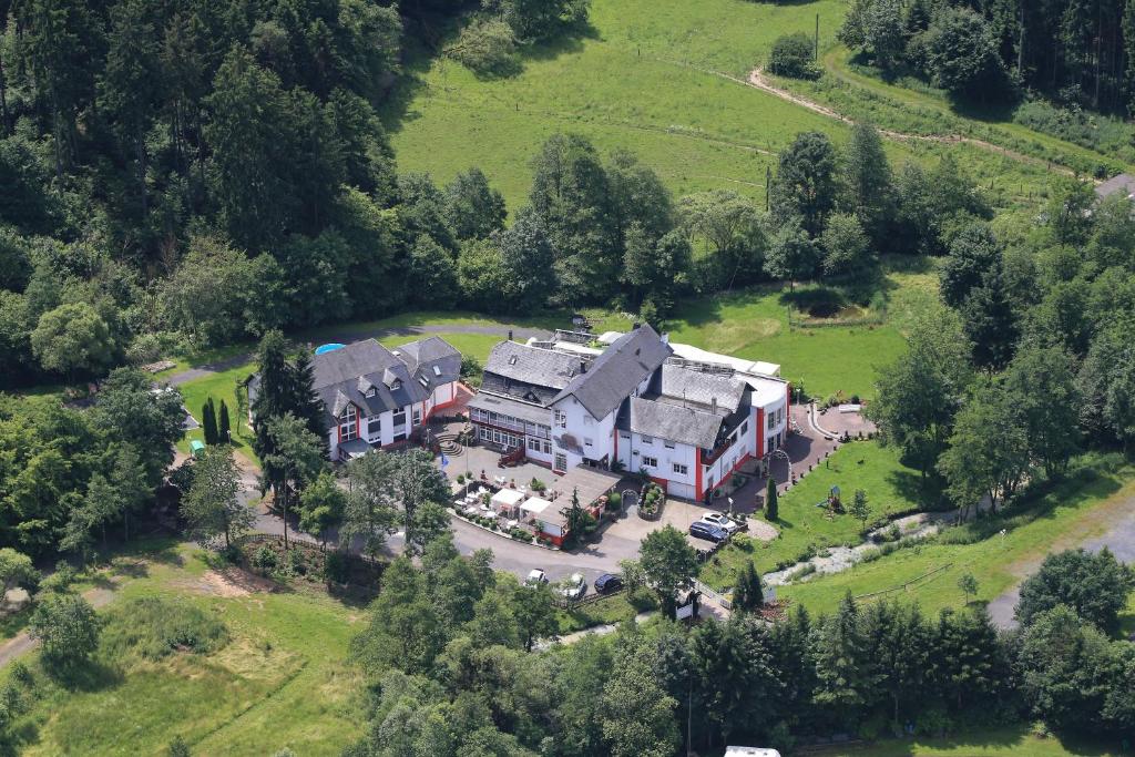 an aerial view of a large house in a field at Studentenmühle Hotel - Restaurant in Nomborn