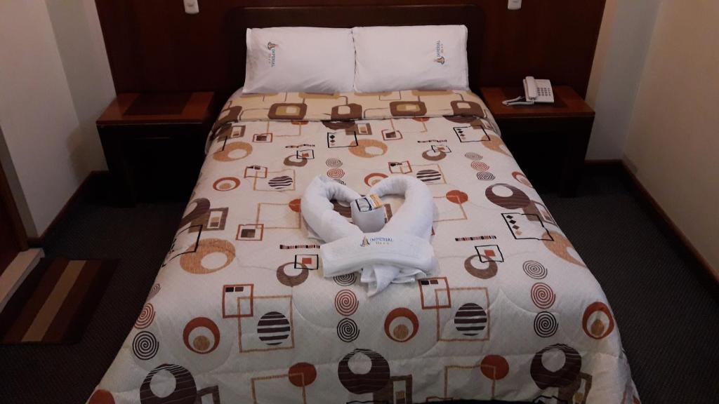 Postel nebo postele na pokoji v ubytování Hotel Imperial