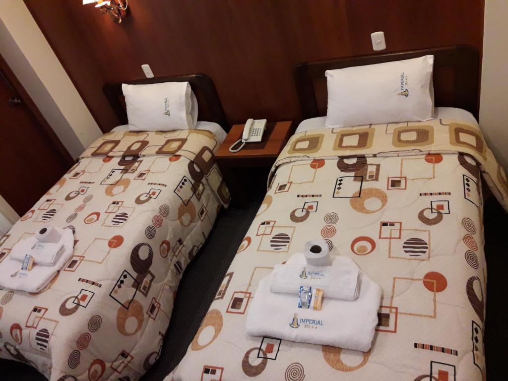 Postel nebo postele na pokoji v ubytování Hotel Imperial