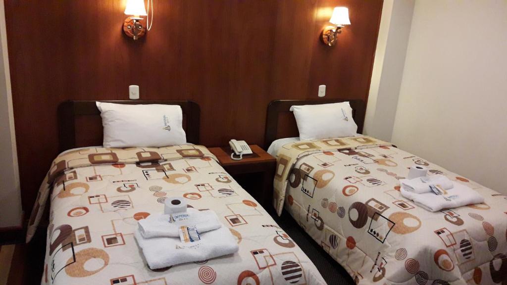 Postel nebo postele na pokoji v ubytování Hotel Imperial