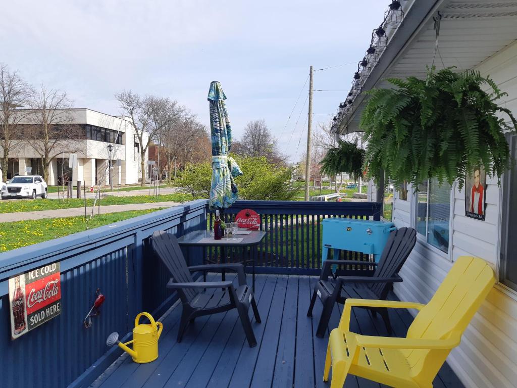 a blue deck with chairs and a table on it at Gracies Fallsview Getaway in Niagara Falls