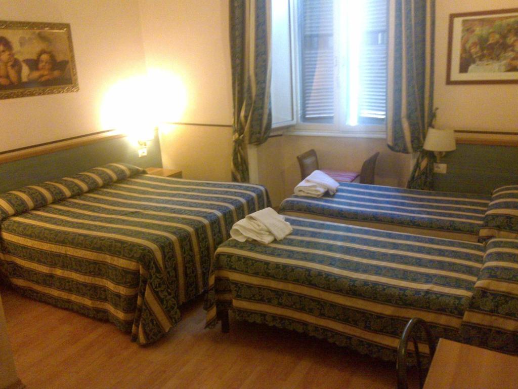 Postel nebo postele na pokoji v ubytování Hotel Lazzari
